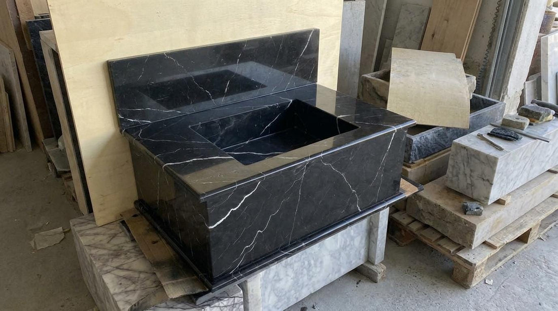 Black Nero Marquina marble sink with integrated backsplash, handcarved fluted stone basin