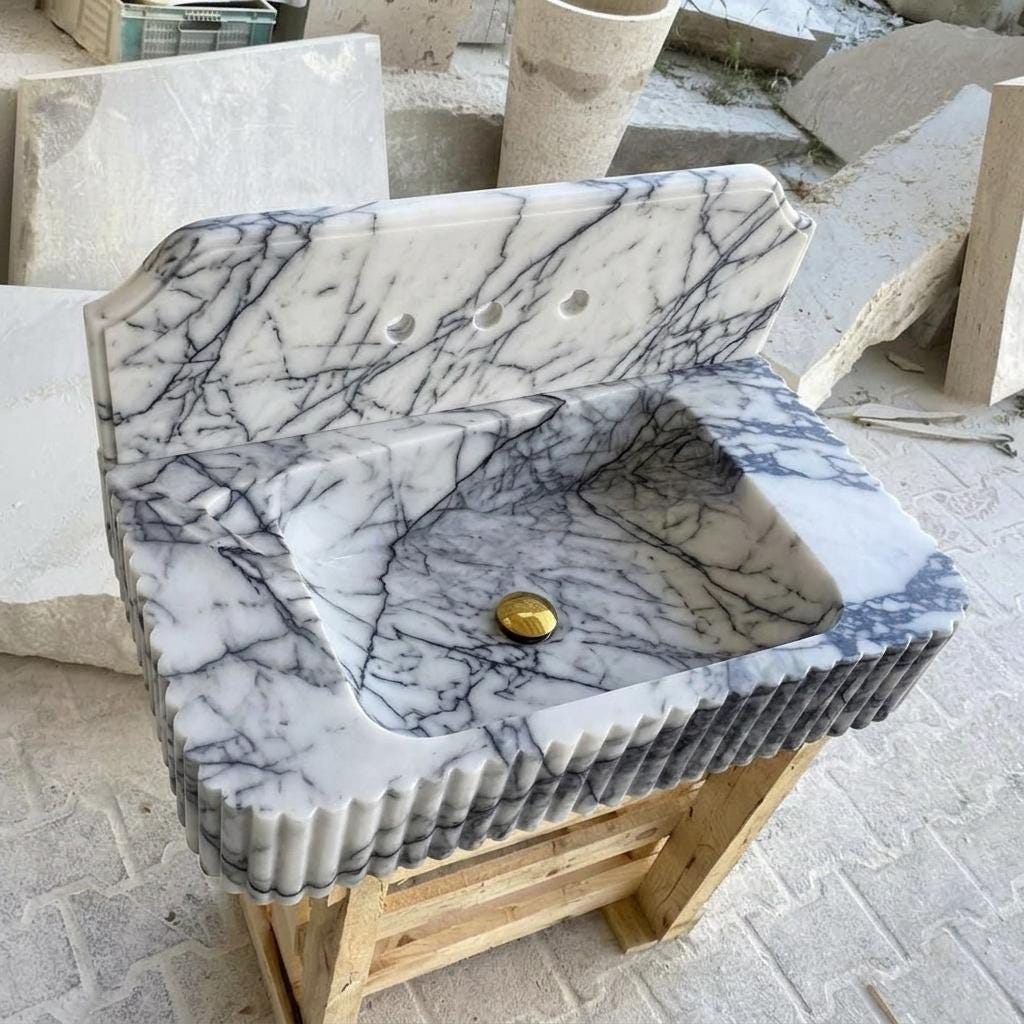 Lilac marble vessel sink carved from a Milas block, in the workshop yard