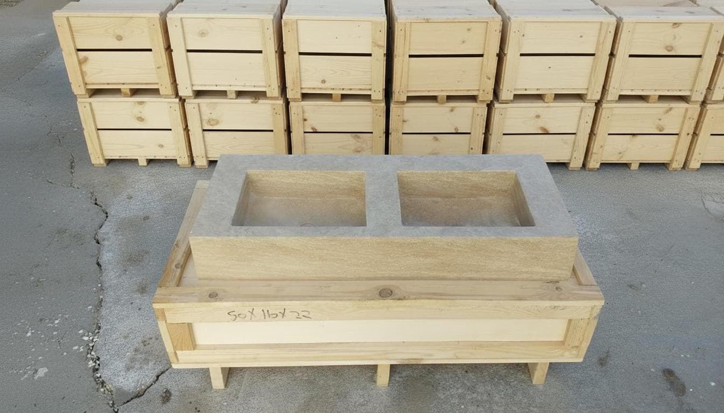a wooden structure with two rectangular openings, likely intended for use in a kitchen or other similar setting. The structure is surrounded by several wooden crates and boxes, suggesting it may be a part of a larger construction or storage project.