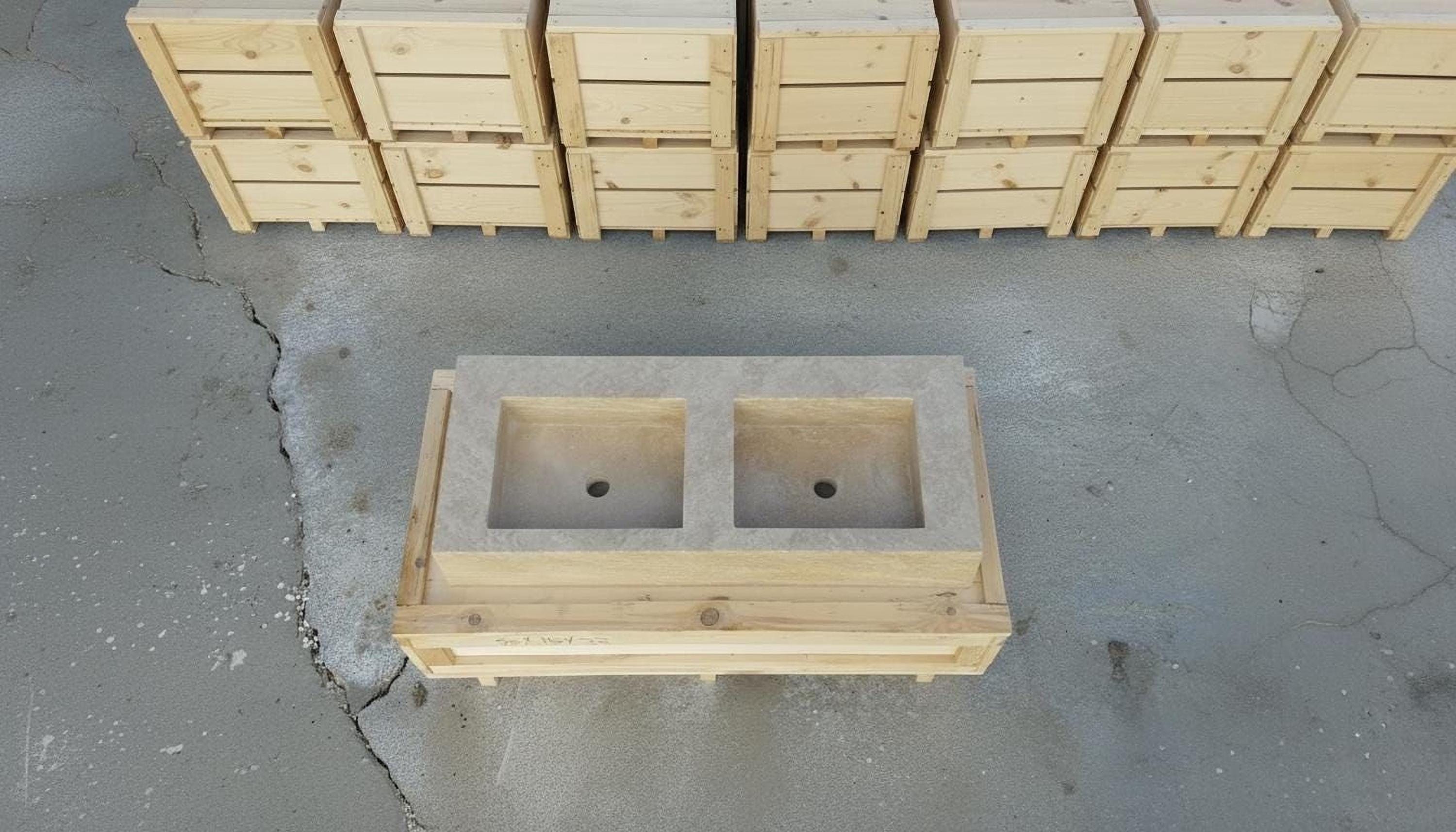 a wooden structure with two square basins, likely intended for use in a kitchen or bathroom setting. The structure is made of wood and appears to be a sink or basin unit. The image is taken from an overhead perspective, providing a clear view of the structure and its surroundings.