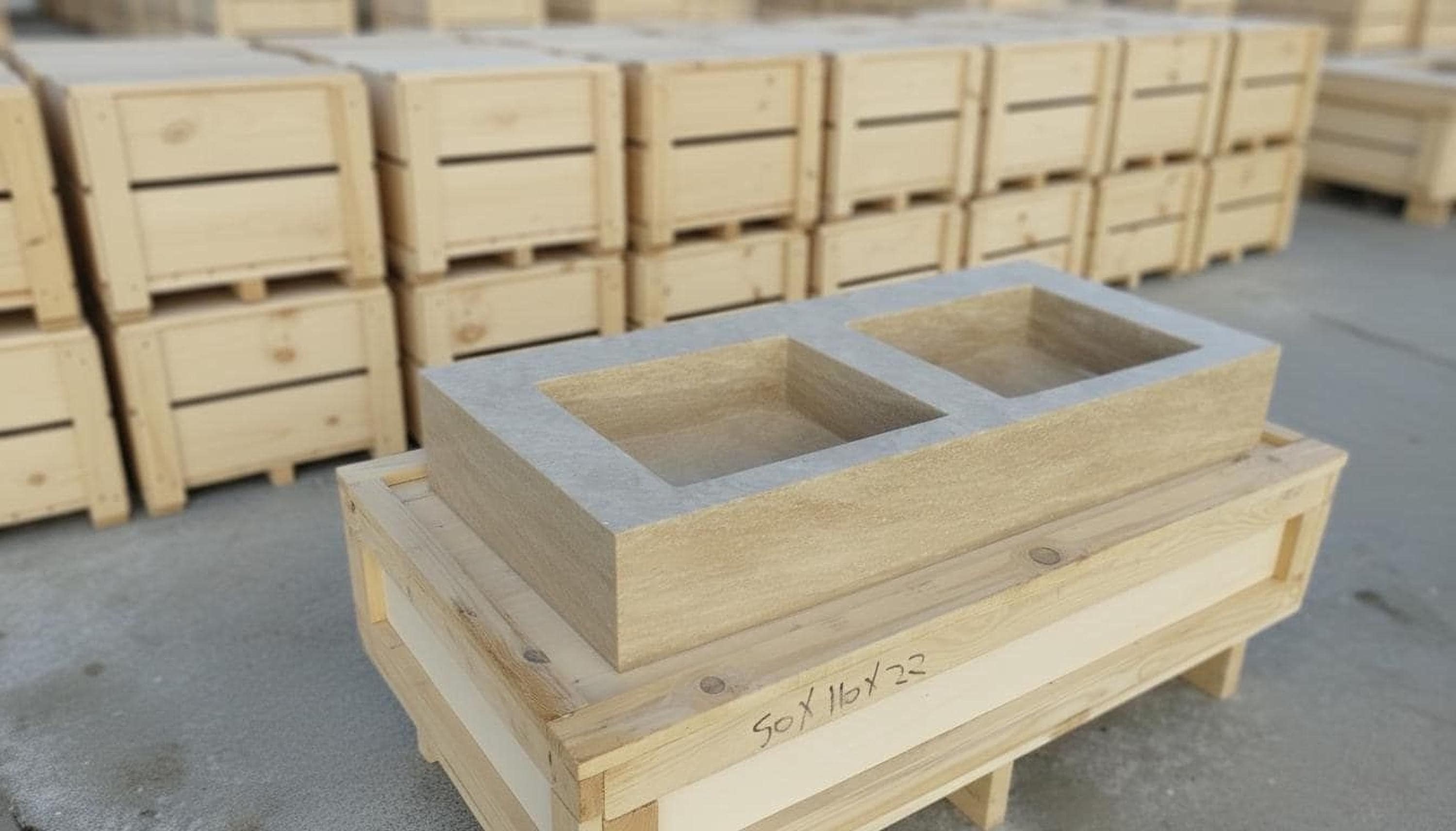 a large number of wooden crates and boxes stacked on top of each other, with a large rectangular object in the foreground.
